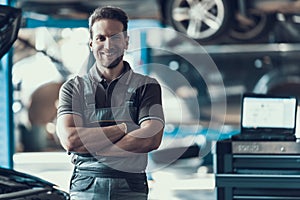 Handsome Smiling Car Machanic Standing in Garage