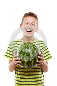 Handsome smiling child boy holding green watermelon fruit