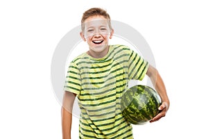 Handsome smiling child boy holding green watermelon fruit