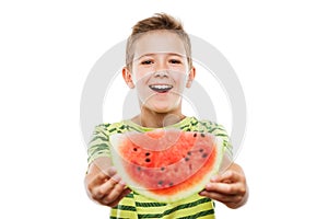 Handsome smiling child boy holding red watermelon fruit slice