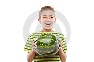 Handsome smiling child boy holding green watermelon fruit