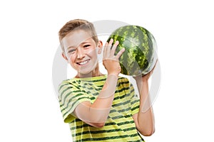 Handsome smiling child boy holding green watermelon fruit