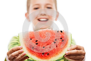 Handsome smiling child boy holding red watermelon fruit slice