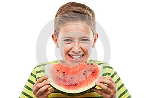 Handsome smiling child boy holding red watermelon fruit slice