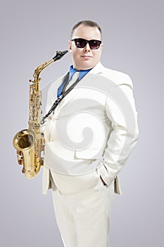 Handsome Smiling Male Saxo Player in Stylish White Suit and Sung