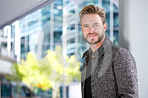 Handsome smiling man with beard outside