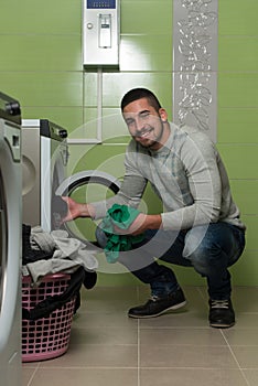 Handsome Smiling Man In The Laundry Room