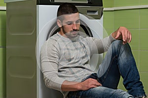 Handsome Smiling Man In The Laundry Room