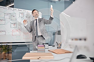 Cheerful businessman using modern smartphone at work