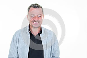 Handsome smiling middle aged man smiling joyful cheerful in studio shot isolated on white background