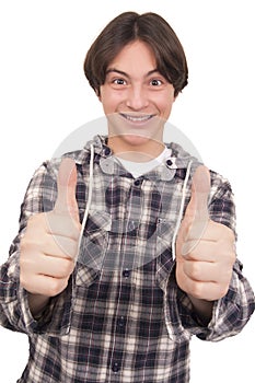 Handsome smiling teenager showing thumbs up