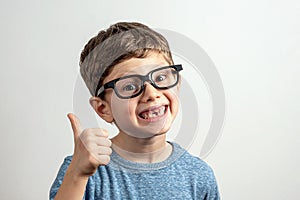 Handsome smiling toothless boy thumbs up photo