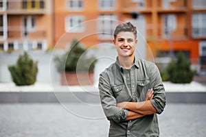 Handsome smiling young man portrait. Cheerful man looking at camera