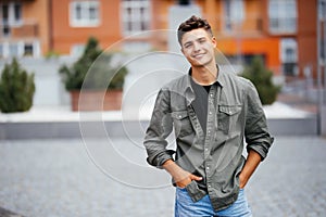 Handsome smiling young man portrait. Cheerful man looking at camera