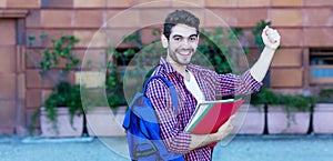 Handsome spanish male student cheering about graduation