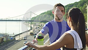 Lovely sports couple relaxing after morning workout in an urban city