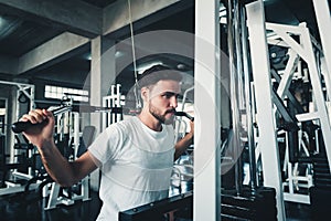 Handsome Sporty Man is Exercising With Lifting Machine in Fitness Club.,Portrait of Strong Man Doing Working Out Calories Burning 