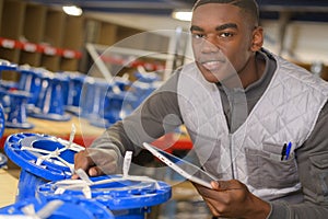 Handsome store manager with computer tablet in warehouse
