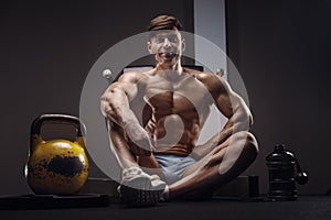 Handsome strong athletic man next to a kettlebell