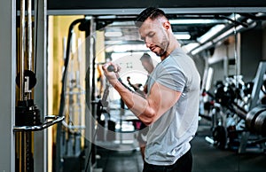 Handsome strong athletic man working triceps and biceps muscles. workout fitness and bodybuilding healthy concept