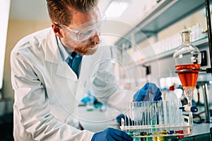 Handsome student of chemistry working in laboratory