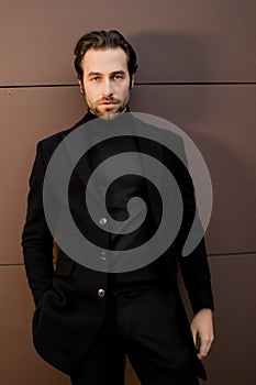 Handsome stylish man is working as a model for fashion magazine, posing for the photo. Successful business male in