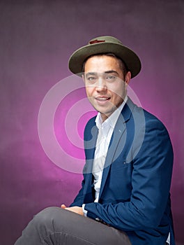 Handsome successfull businessman in blue suit sitting and showing expressions