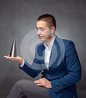 Handsome successfull businessman in blue suit sitting and showing expressions