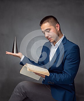 Handsome successfull businessman in blue suit sitting and showing expressions