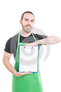 Handsome supermarket employee holding and showing clipboard