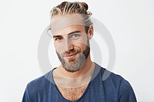 Handsome swedish mature guy with great hairstyle and beard smiling, looking in camera with confident and flirty