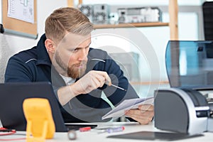 handsome technician repairing computer