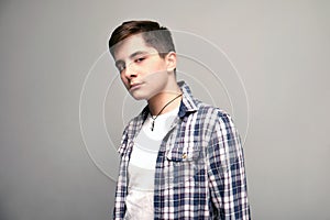 Handsome teenage boy looking at camera, studio shot