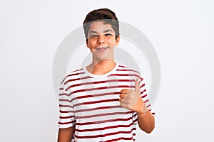 Handsome teenager boy standing over white isolated background doing happy thumbs up gesture with hand