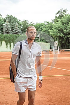 handsome tennis player after training on tennis