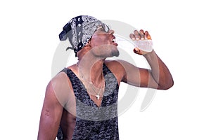 Handsome thirsty young man drinking a bottle of mineral water