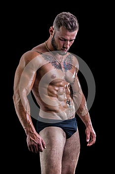 Handsome topless muscular man standing