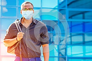 Handsome trendy African American university lecturer male with glasses in stylish clothes black shirt with a backpack on