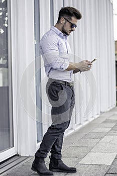 Handsome trendy man talkiing on cell phone