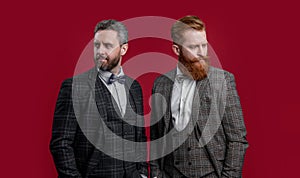 handsome tux men with bowtie isolated on burgundy background. two men in tux bowtie.