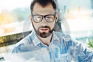 Handsome unshaken man observing something interesting in it.