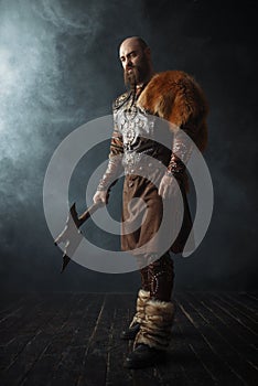 Handsome viking with axe, nordic barbarian image