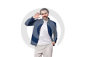 handsome well-groomed young brunette man in a denim shirt on a white background