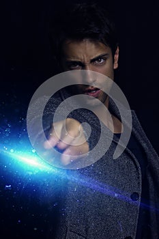 Handsome wizard man holding magic wand