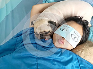 Handsome woman resting and sleeping rest with her pug dog annoy