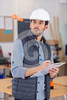 handsome worker looking at hanged carrot - motivation concept