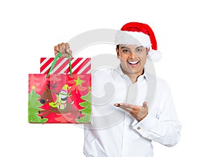 Handsome xmas man smiling and excited about his festive bag