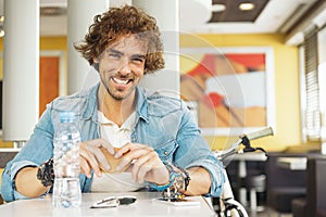 Handsome youn man take a break in restaurant.