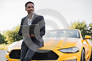 Handsome young African American business man working with laptop