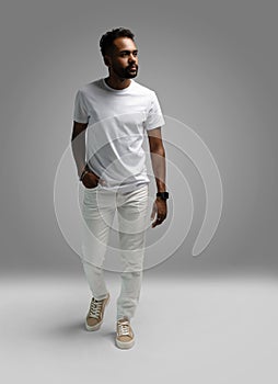 Handsome young african american guy posing in studio - isolated